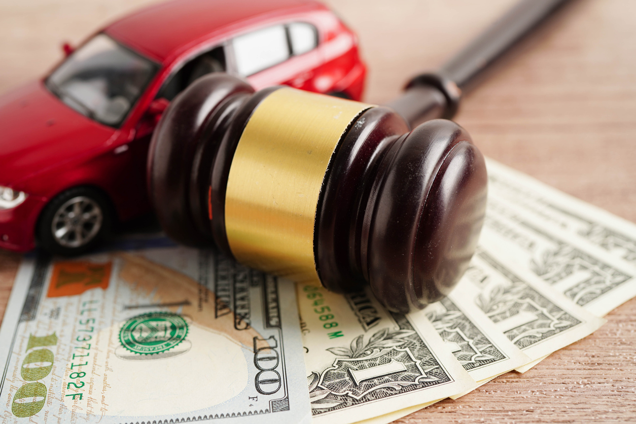 Car accident lawsuit and insurance, Judge hammer and money with car model. We Fight for the Outcome You Deserve